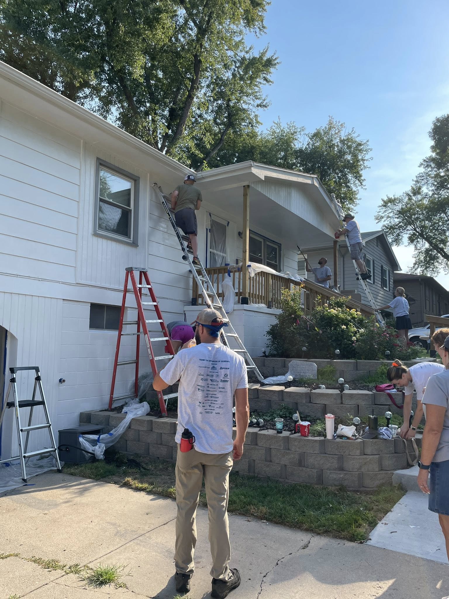 Employees painting house