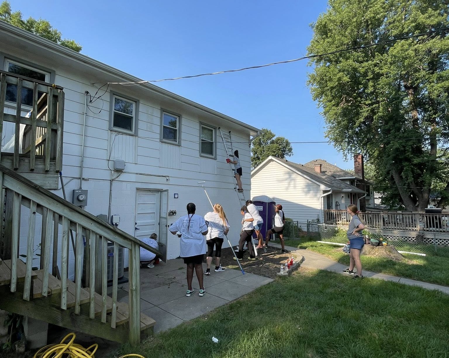 Employees painting house