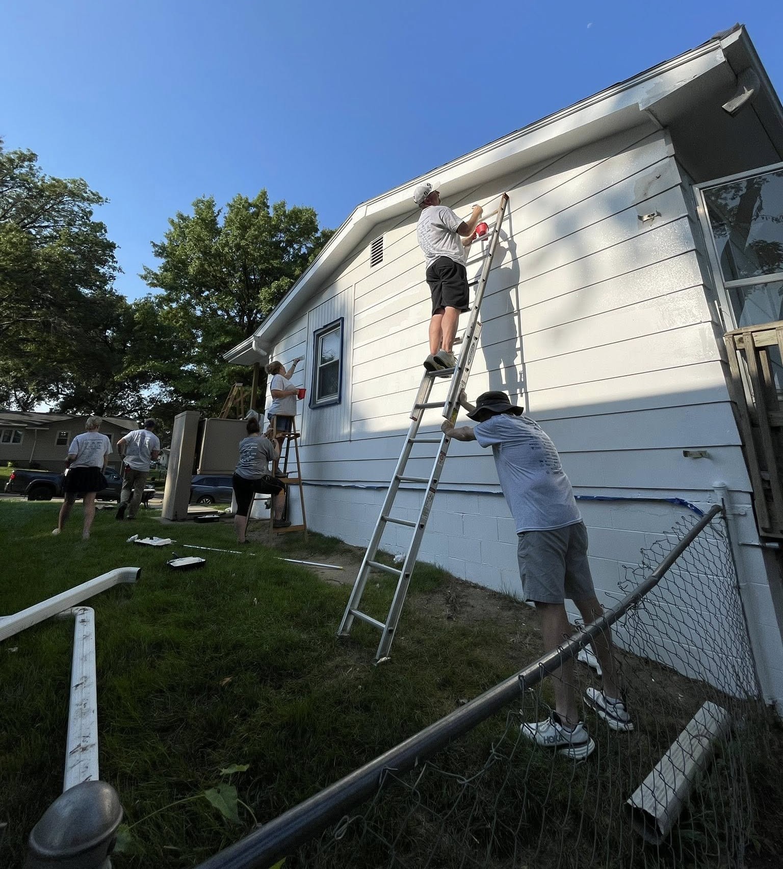 Employees painting house
